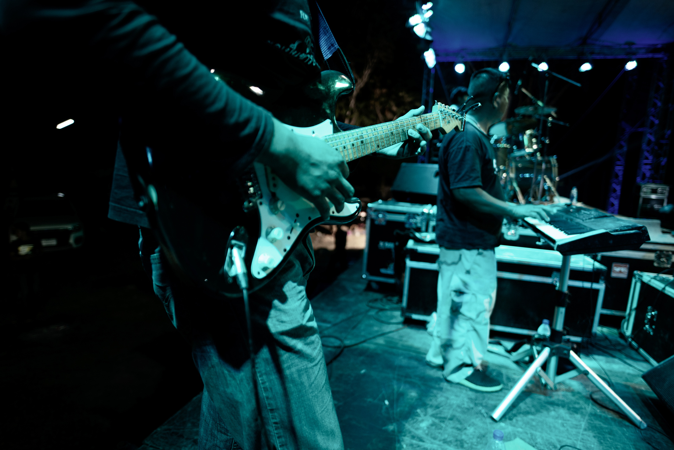 Rock Band Performs Live at Rock Show on Stage. Guitarist, Bass G