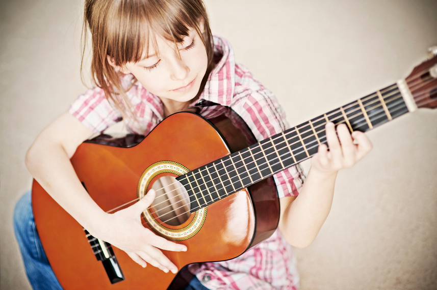 Little girl playing the guitar